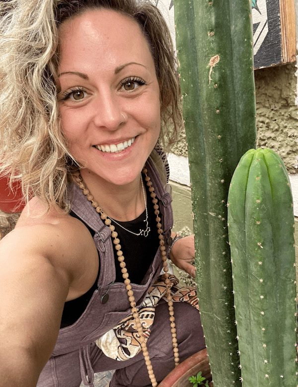 Dani Reardon, Secretary of the Huachuma Foundation, beside a tall Huachuma cactus